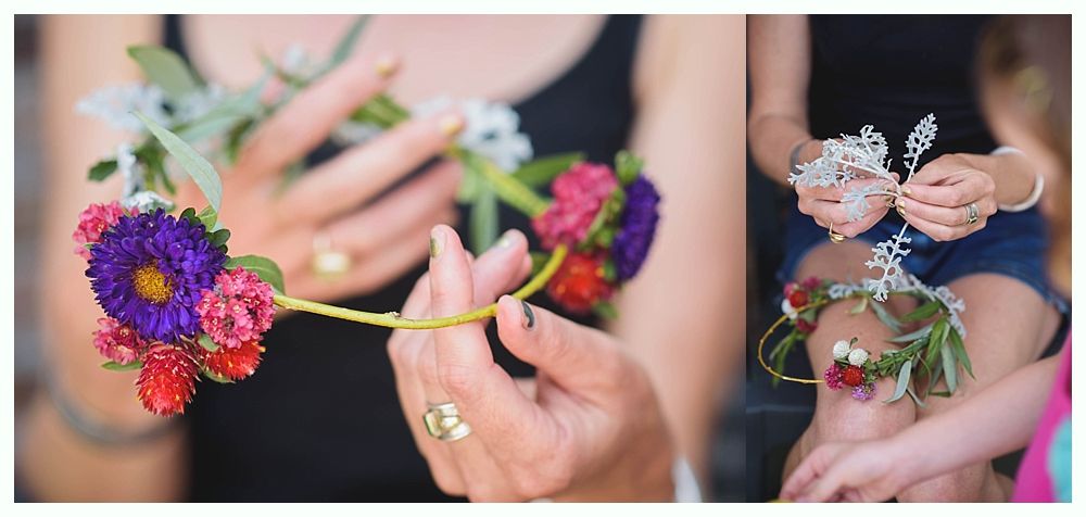 Bride and groom embrace on a beach. Ocean, blue sky, and tree branch in the foreground.