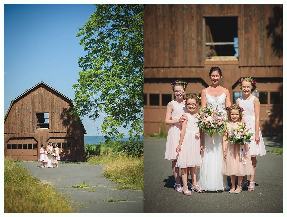 Bride with arms up, making a funny face, groom looking at his hand, cake cutting in background.