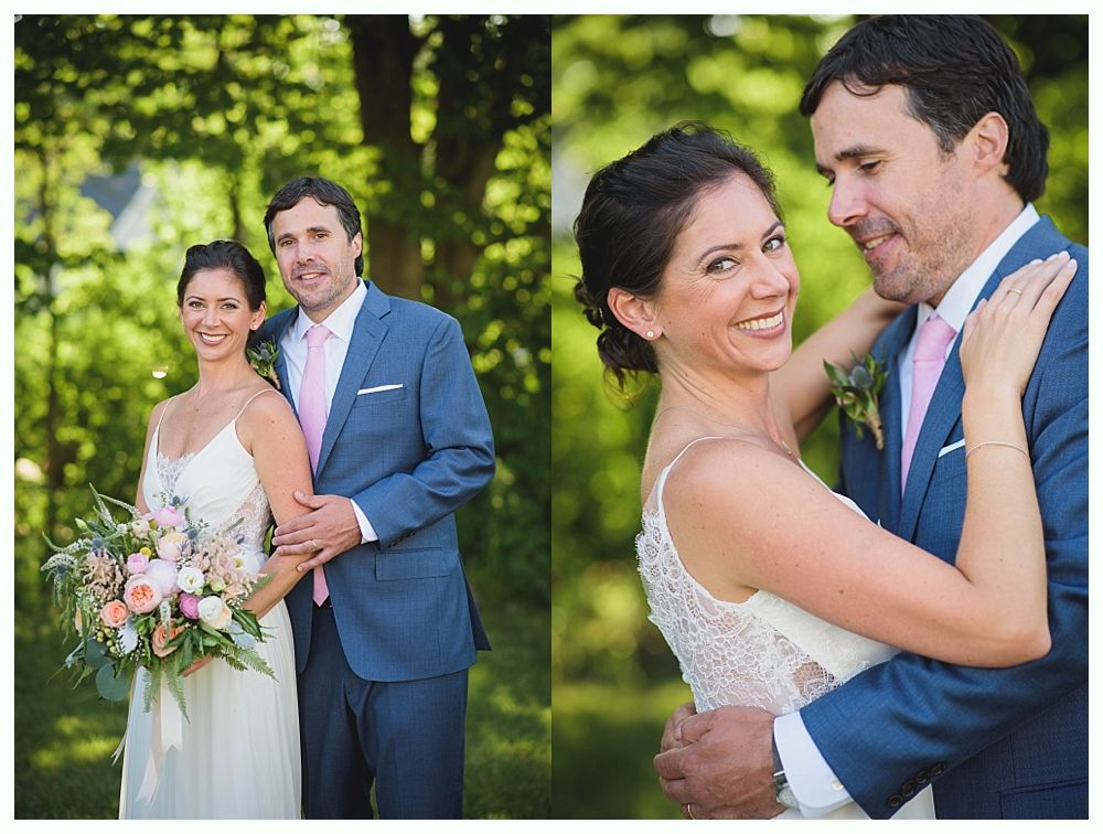 Bride with arms up, making a funny face, groom looking at his hand, cake cutting in background.