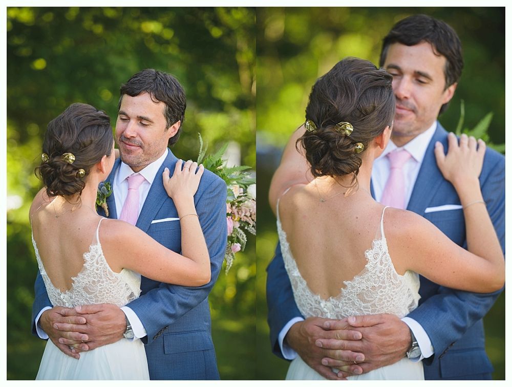Bride with arms up, making a funny face, groom looking at his hand, cake cutting in background.