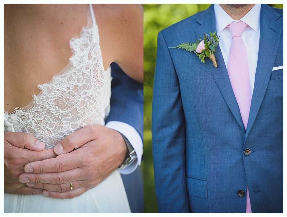 Bride with arms up, making a funny face, groom looking at his hand, cake cutting in background.