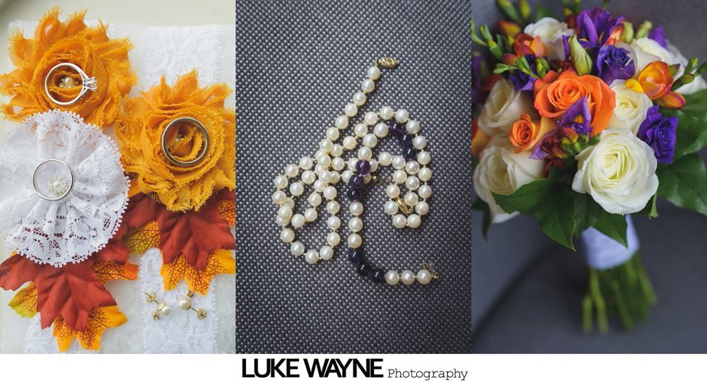 Wedding dress hanging, makeup supplies on table.