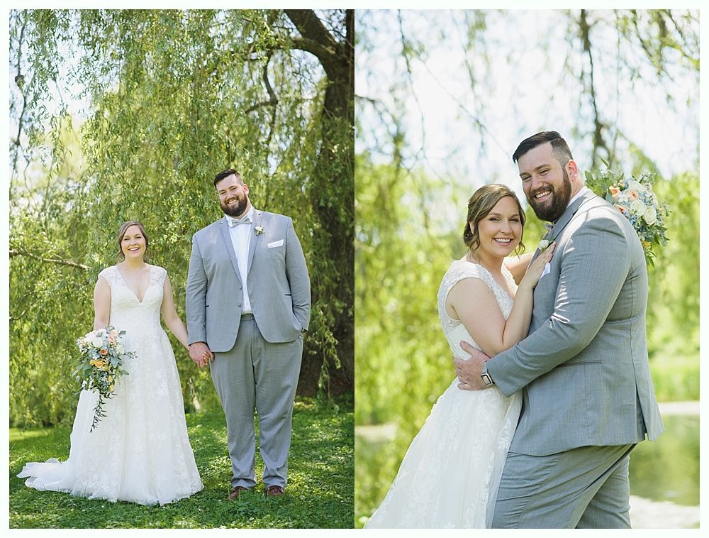 Wedding couple holding hands and smiling outdoors in a park, beside a weeping willow.