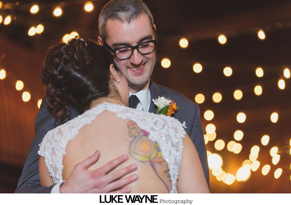 Triptych: stone statue, a sign with wedding details, and floral arrangement in a pumpkin.