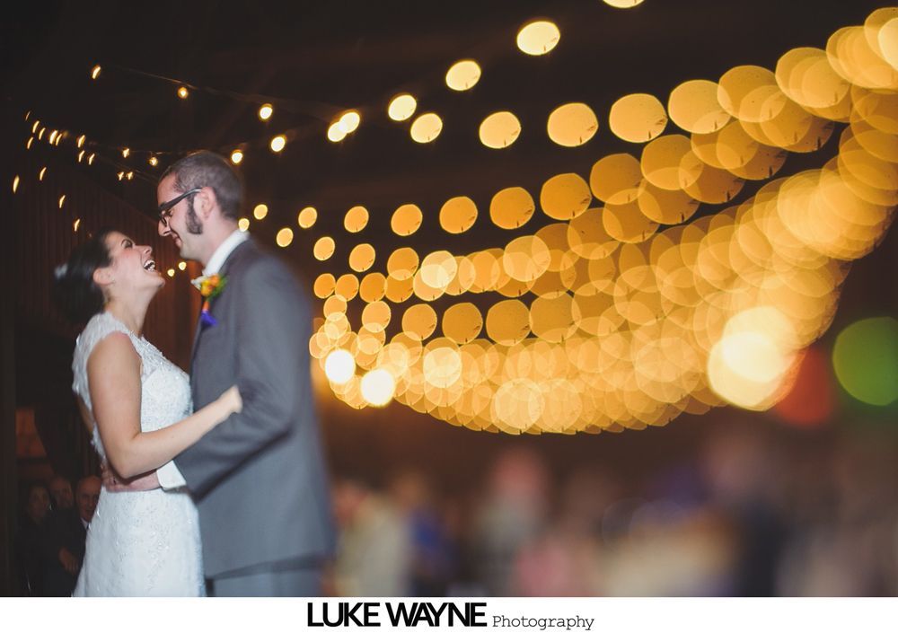 Bride and groom walking down aisle after outdoor wedding ceremony. Guests watch.