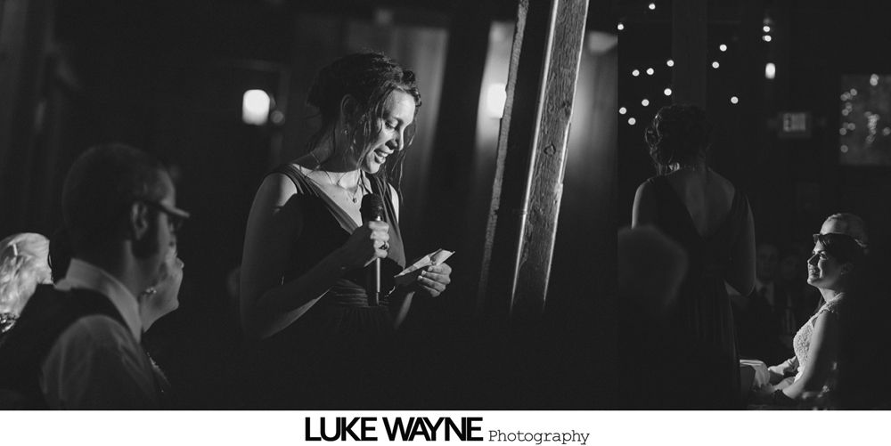 Wedding ceremony: Bride and groom shake hands, smiling, outdoors. Groom wears a black suit, bride a white dress.