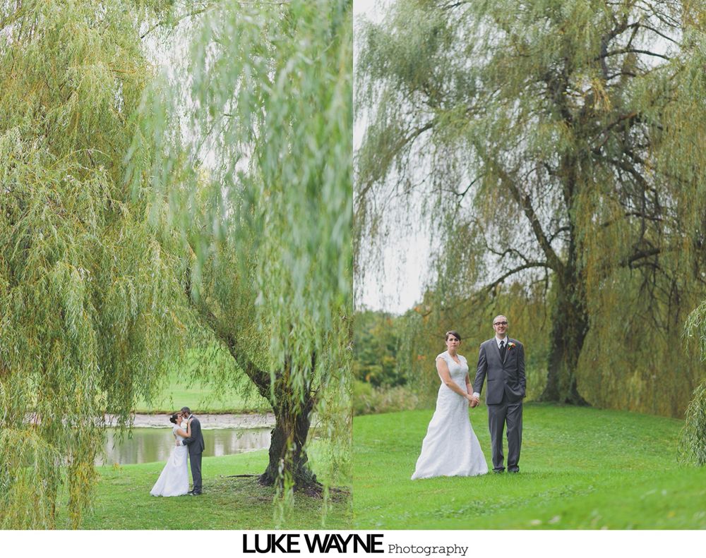 Bride and groom celebrating at an outdoor wedding ceremony, surrounded by the wedding party and guests.