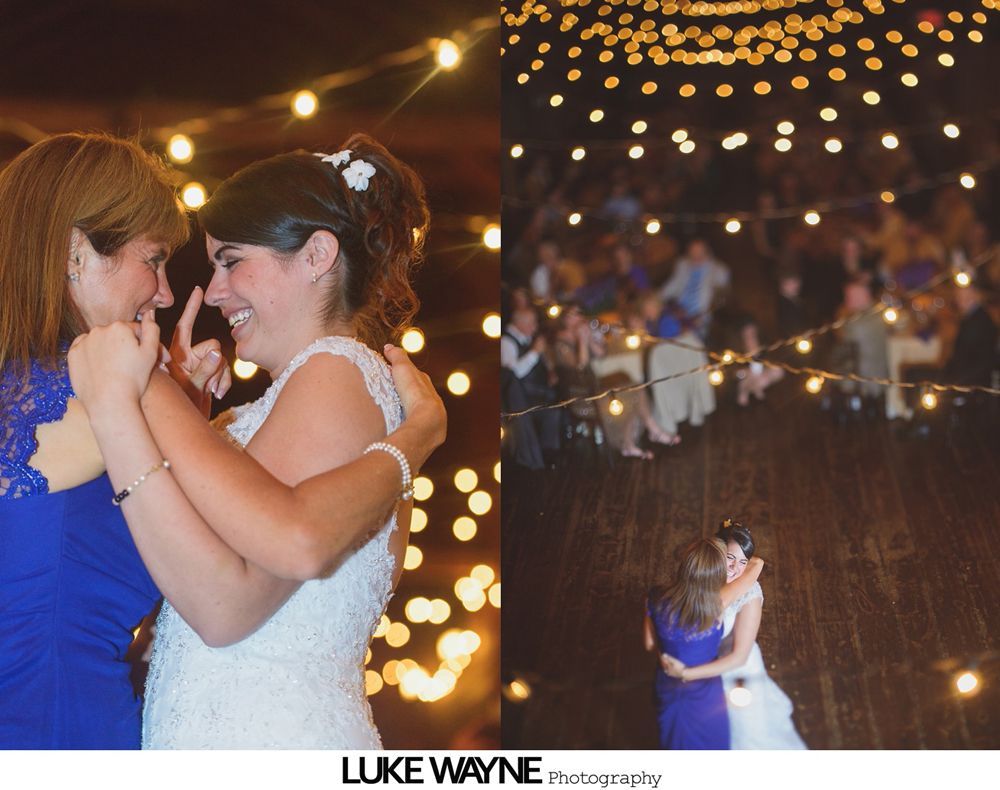 Wedding reception with dancing; bride in a white gown and guests in colorful dresses on a dance floor.