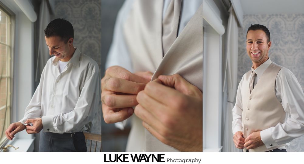 Man adjusts sleeves, buttons vest and smiles, getting dressed in a light-filled room.