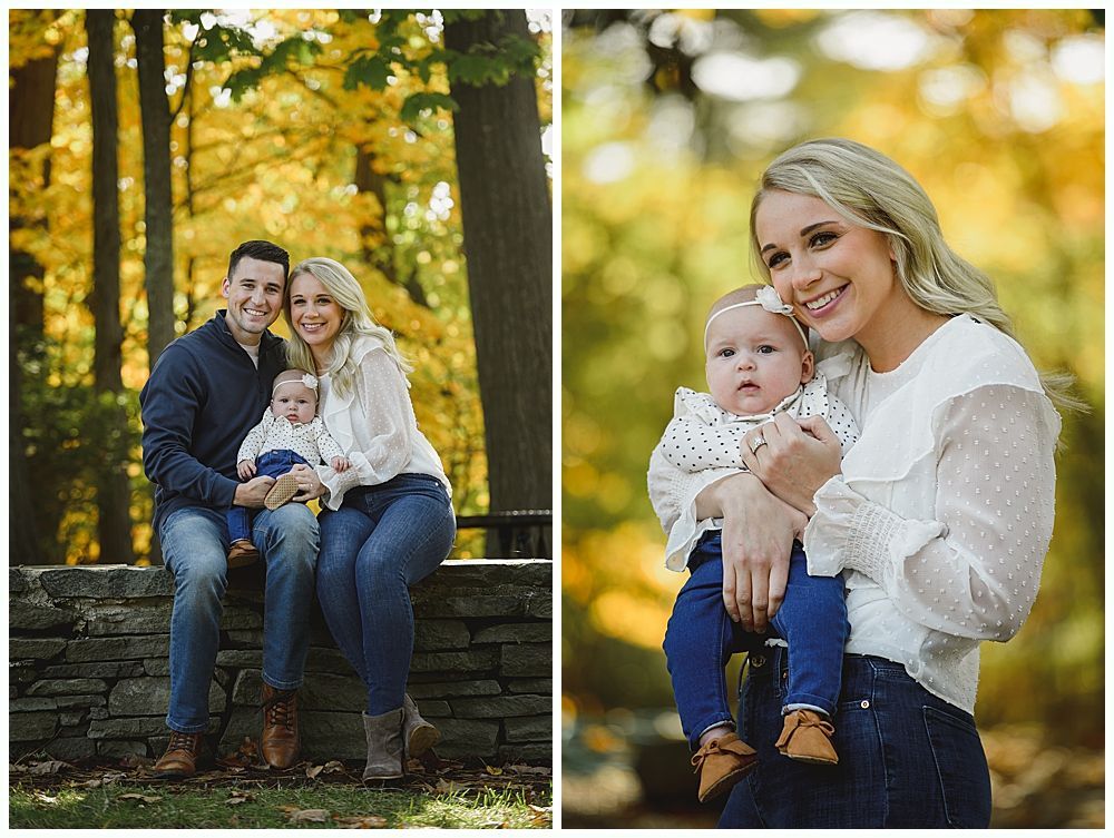 Family portrait: Parents and baby pose outdoors in autumn. Trees with yellow leaves.
