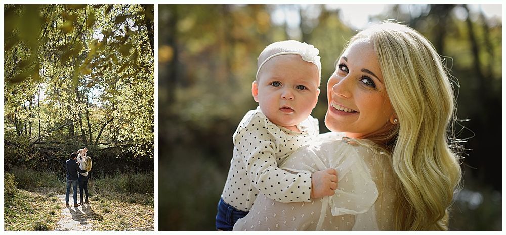 Woman holding a baby outside; smiling at the camera.