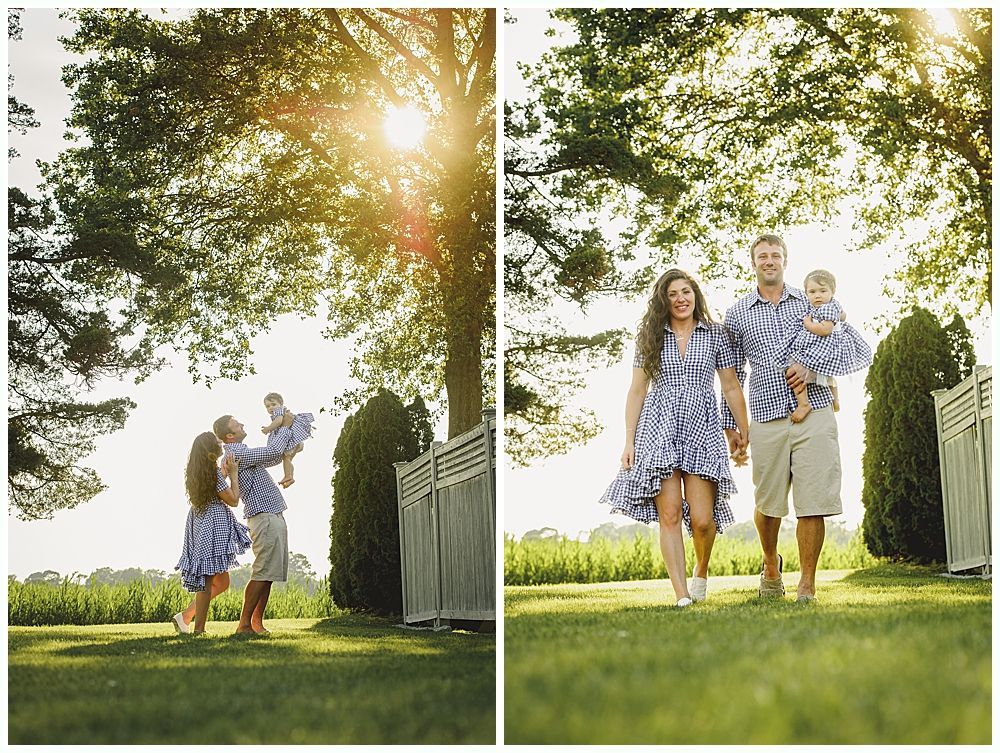 Family in matching blue floral outfits poses on lawn in front of greenery.