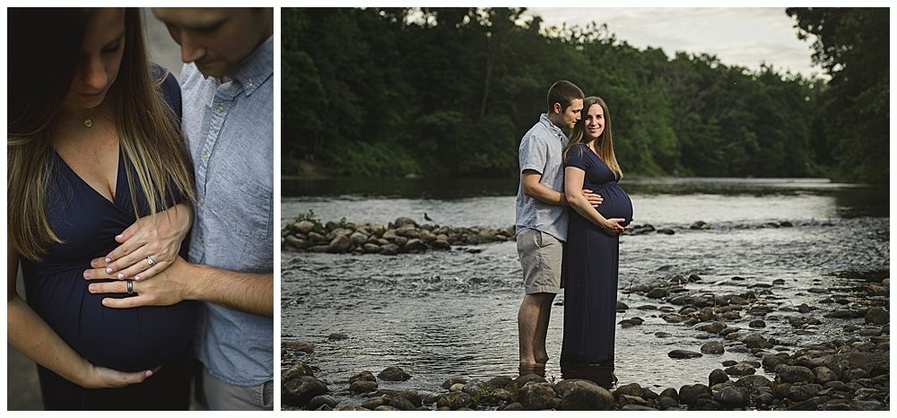 Couple poses outdoors; pregnant woman in blue dress, man in blue shirt, near a river.