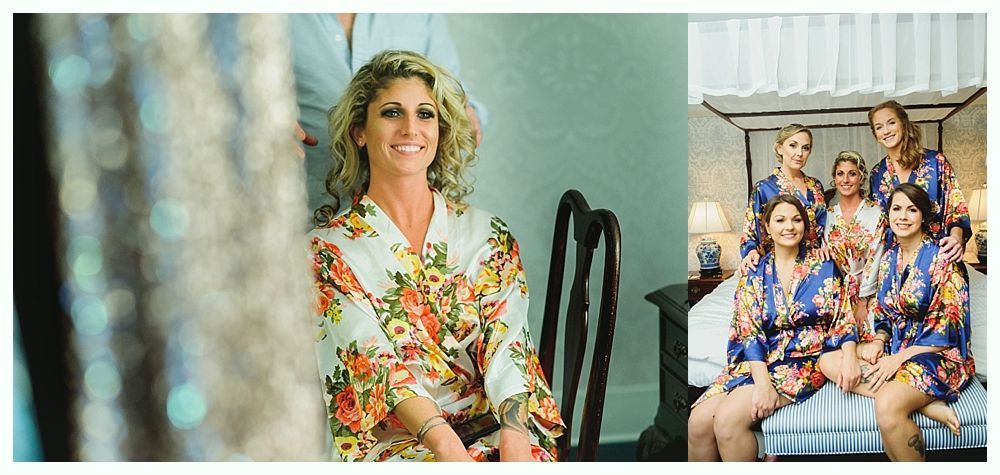 Woman in floral robe smiles; bridesmaids in blue robes on a bed.