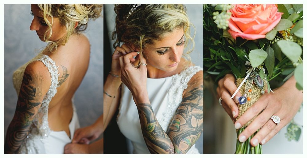 Bride in wedding dress, tattoos visible, putting on earrings, holding bouquet with ring.