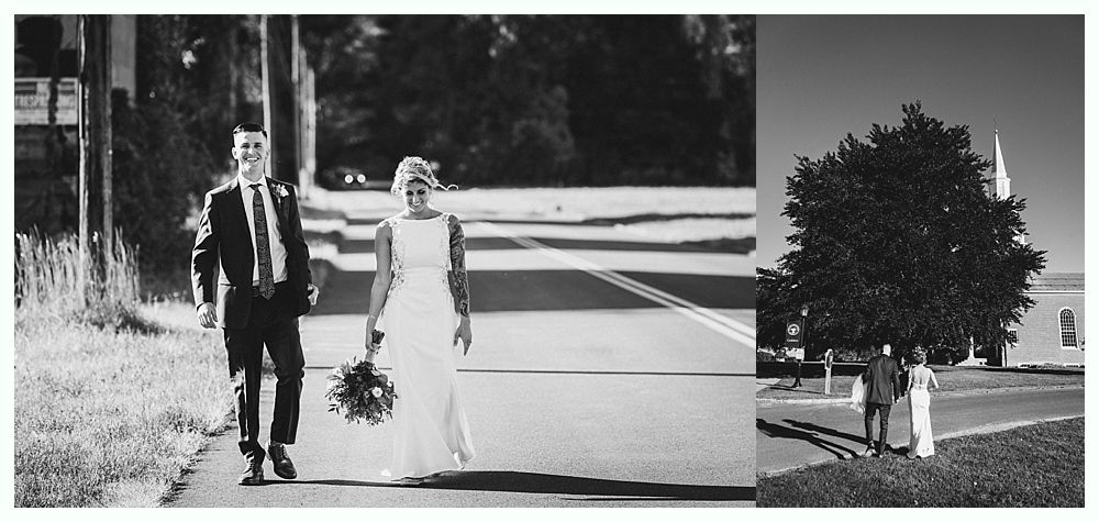 A bride and groom walk together after their wedding ceremony. They are in black and white.