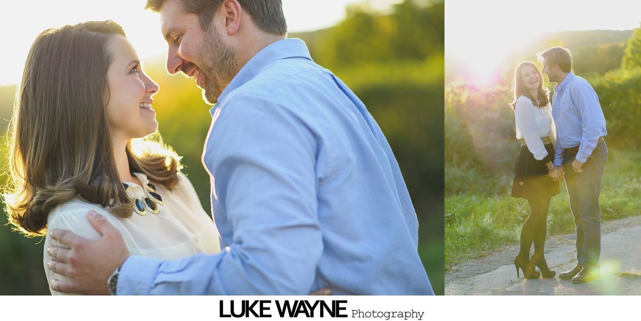 Couple embraces on a beach, faces close, looking at each other. Man in navy shirt, woman in turquoise top.