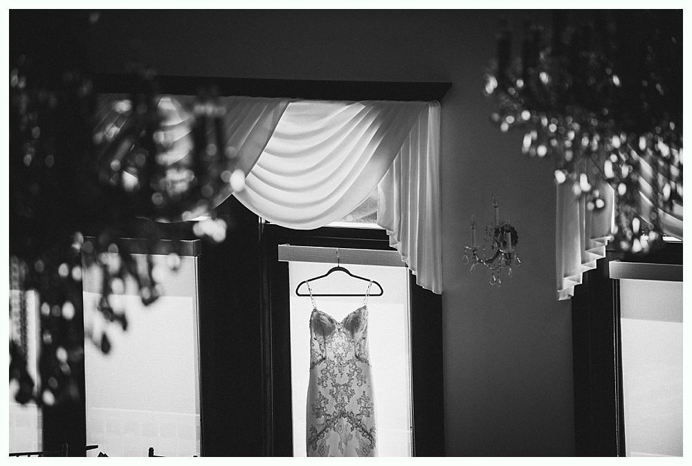 Bride and bridesmaids in navy dresses hold bouquets, posing outdoors.