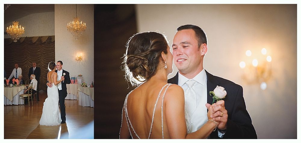 Bride with arms up, making a funny face, groom looking at his hand, cake cutting in background.