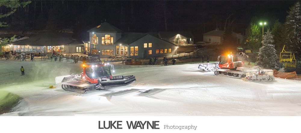 Silhouette of someone applying makeup near a window, natural light.