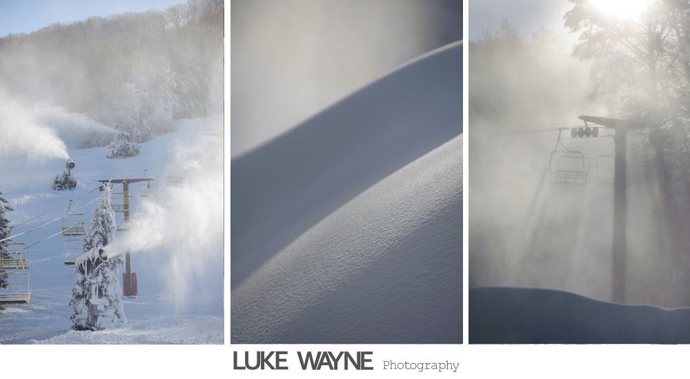 Bride in strapless white dress holding purple flowers, smiling. Dark background with archway.