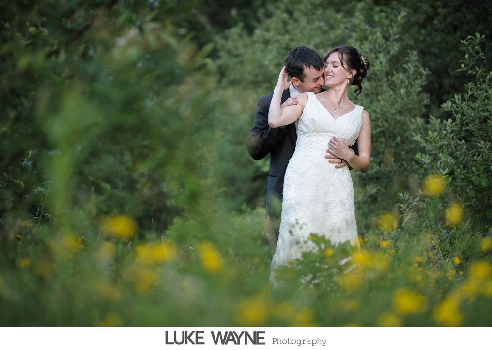 Woman wearing a hat with veil and feathers, in black and white.