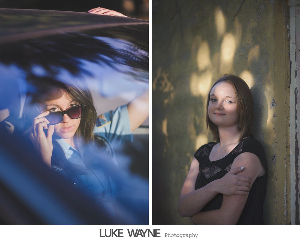 Two wedding dresses hanging in a window, with a chandelier and flowing fabric.