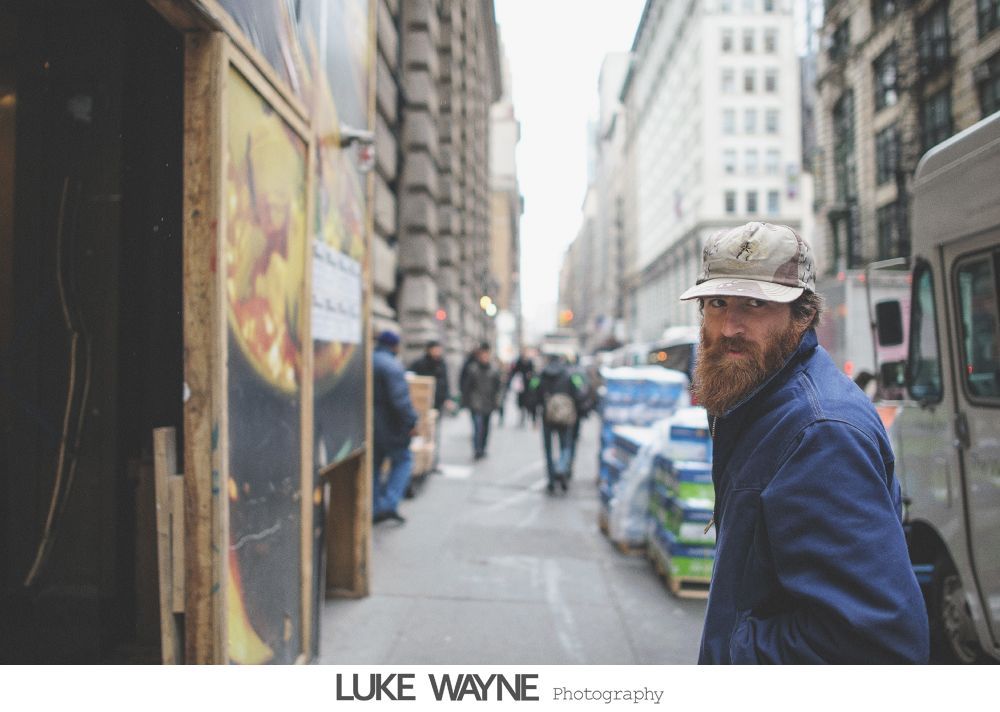 Wedding party on steps, bride in white dress, bridesmaids in purple dresses, groomsmen in gray suits.