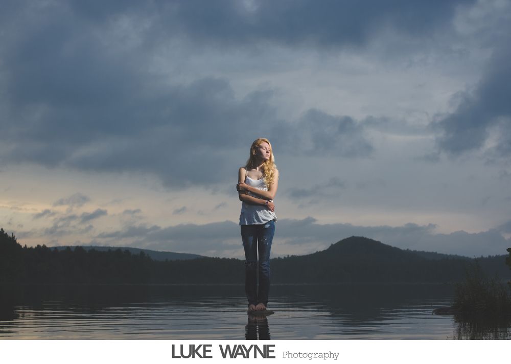 Wedding party posing in bar: bride on bar, groomsmen sprawled on floor, expressions of exhaustion.