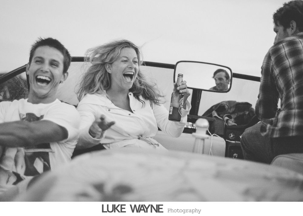 Wedding ceremony: Bride and groom exchanging rings, then kissing in front of large arched window.