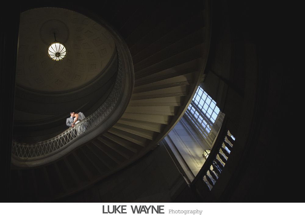 Wedding reception details: cake, flowers, wine, purple and white decor.