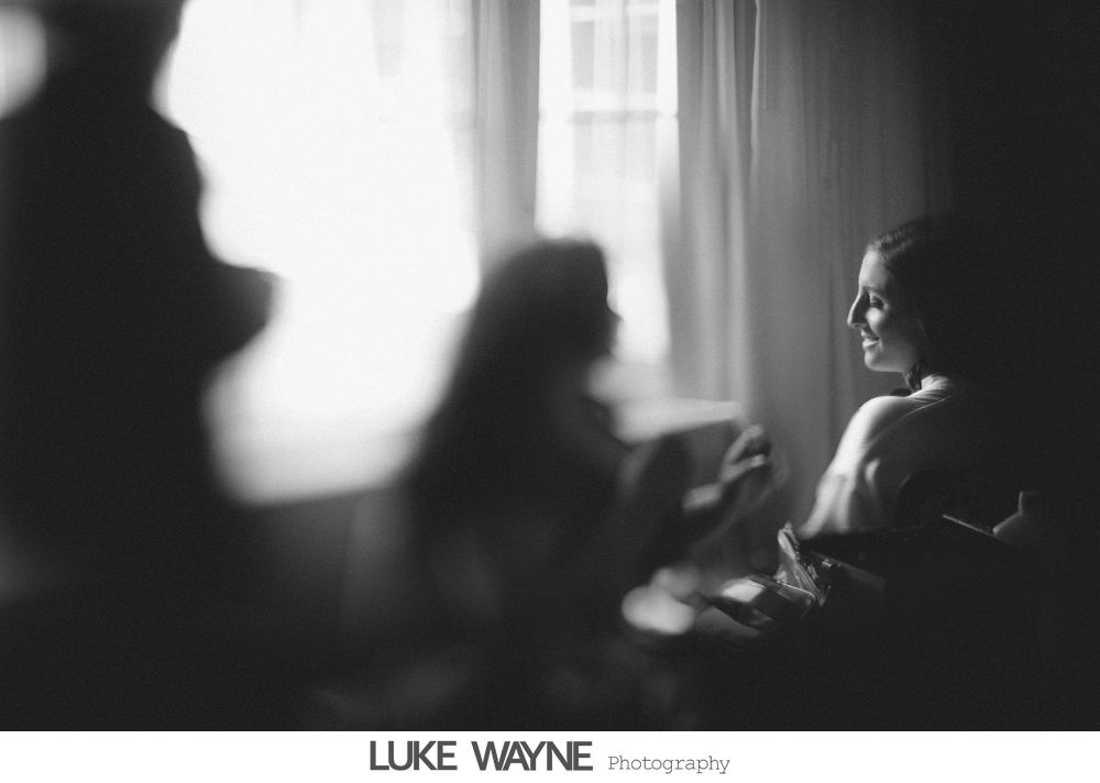 Wedding reception details: cake, flowers, wine, purple and white decor.