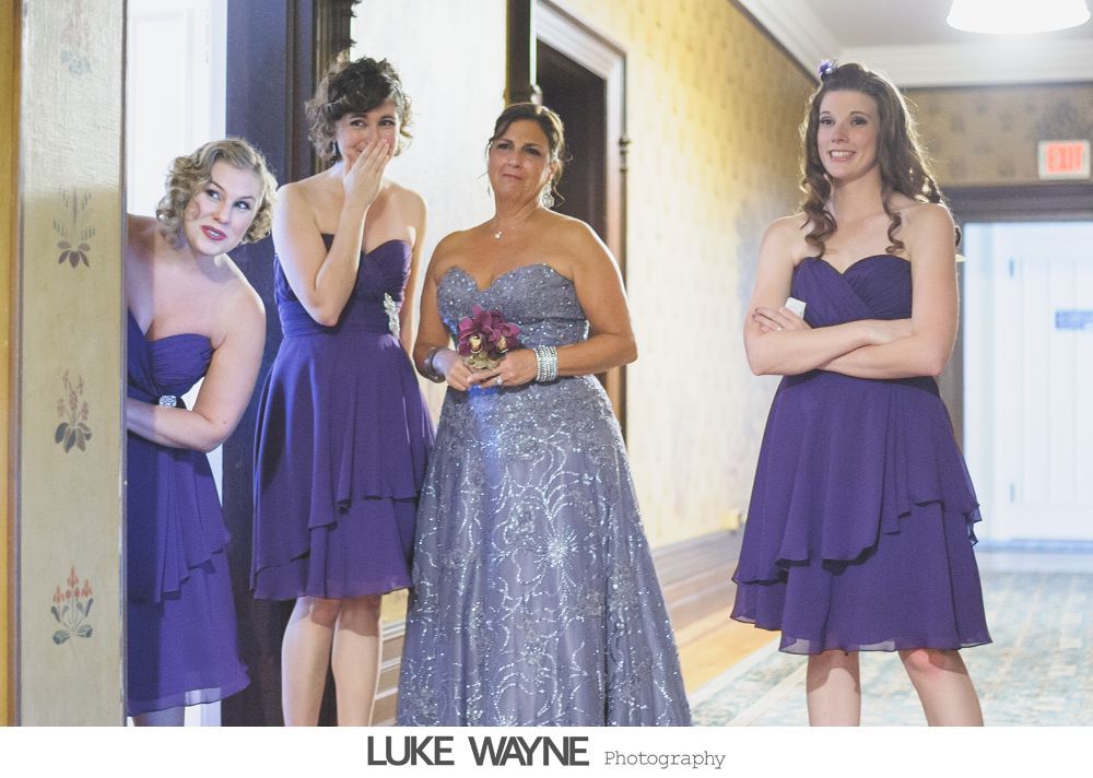 Wedding reception details: cake, flowers, wine, purple and white decor.