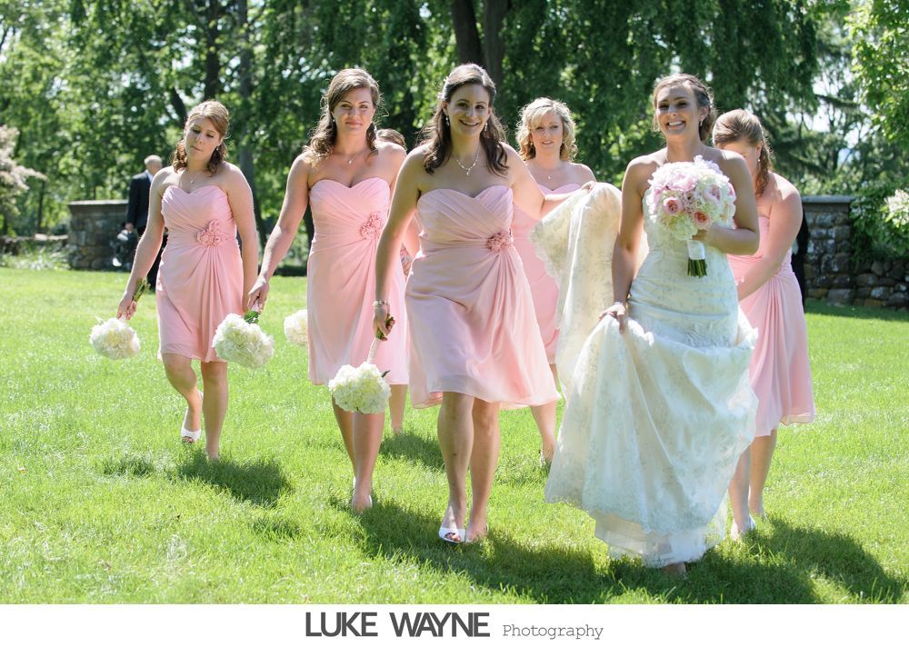 Wedding reception details: cake, flowers, wine, purple and white decor.