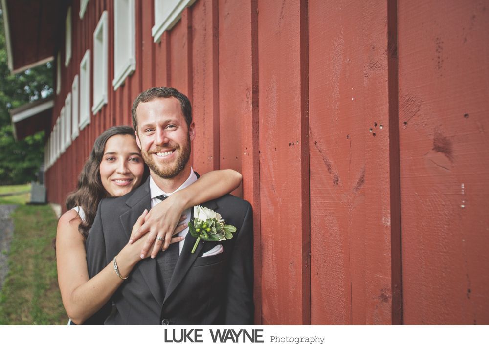 Wedding reception details: cake, flowers, wine, purple and white decor.