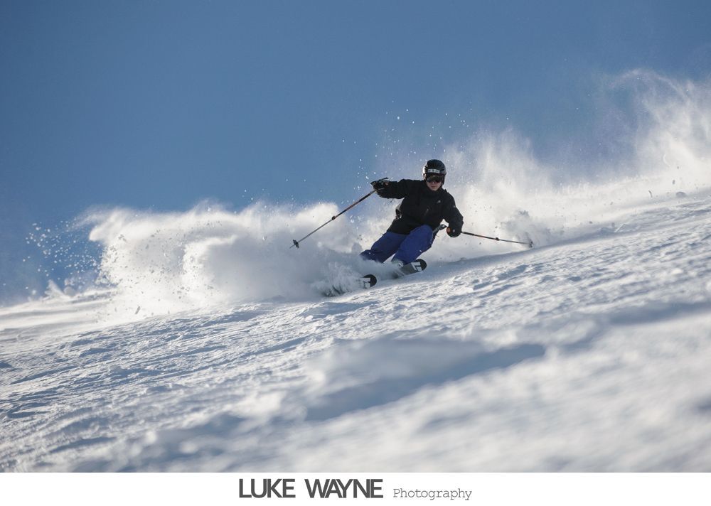 Wedding reception details: cake, flowers, wine, purple and white decor.