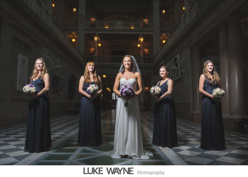 Wedding reception details: cake, flowers, wine, purple and white decor.