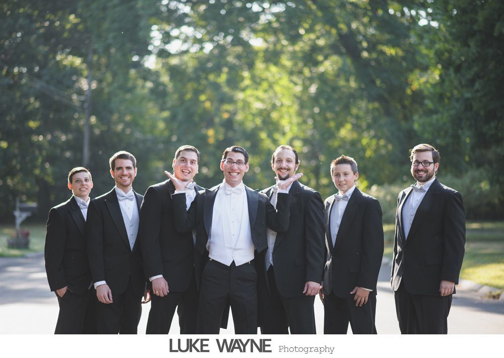 Wedding reception details: cake, flowers, wine, purple and white decor.