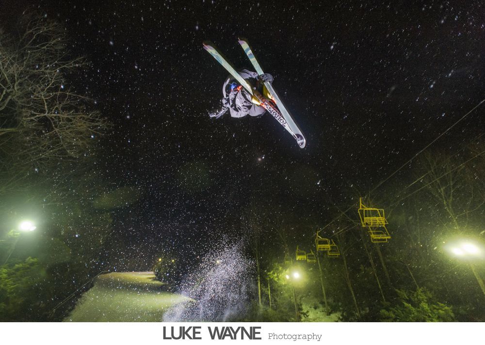 Wedding reception details: cake, flowers, wine, purple and white decor.
