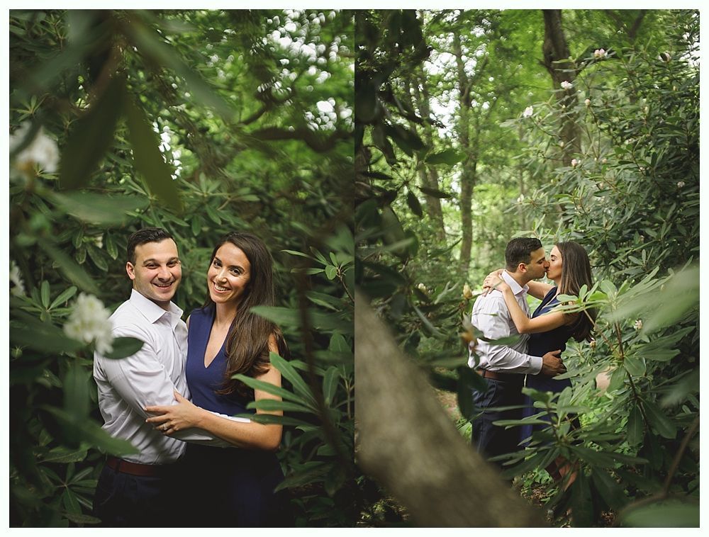 Man wearing a wristwatch, adjusting shirt sleeves near a window, black and white.