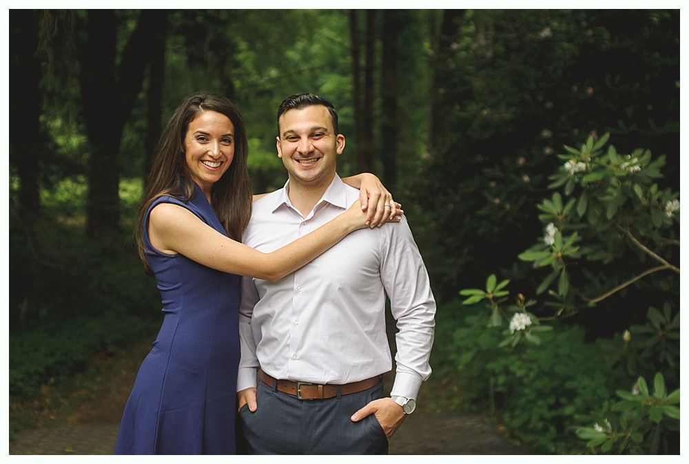 Bride in white lace dress holding a floral bouquet.