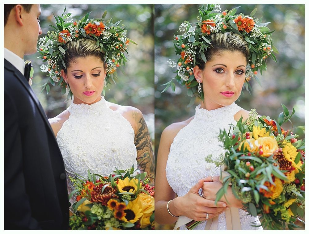 Bride in floral crown and halter dress holds bouquet, groom beside her. Outdoor setting.