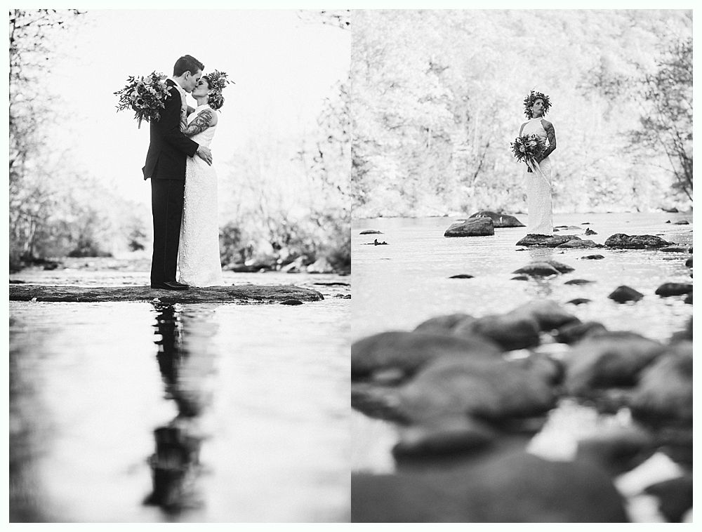 Wedding couple kissing; woman standing in creek holding bouquet. Black and white.