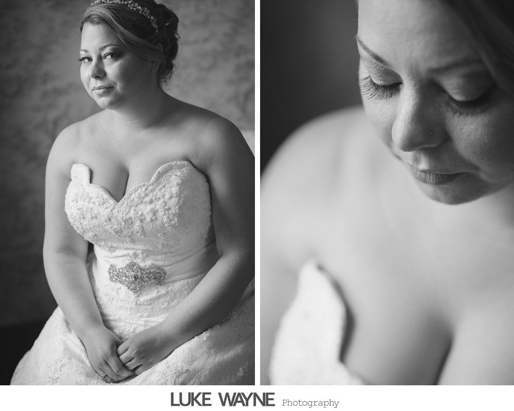 Groomsmen in suits pose at a bar. Dark setting with a festive vibe, men smiling at the camera.