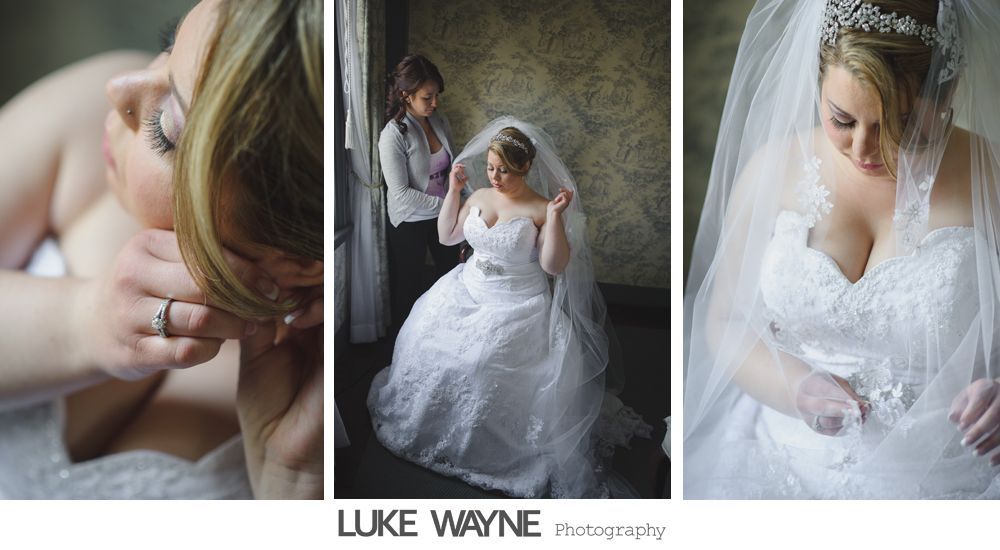 Bride in wedding dress, getting help with veil.