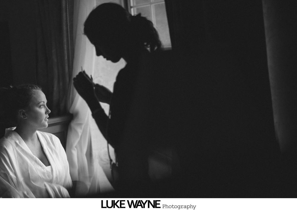 Three floral arrangements: one in a mason jar, one bouquet, one boutonniere; various light pink and white flowers.