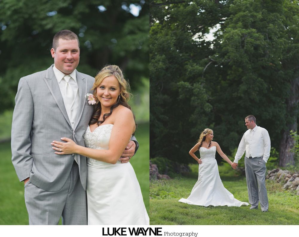 Wedding party posing on a road, with the bride and groom at the center. Some are smiling, others are making silly faces.
