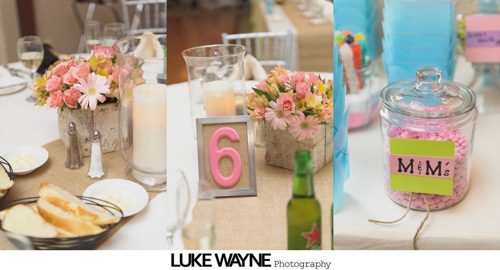 Bride and groom embrace on a country road, laughing, with green field and trees in the background.