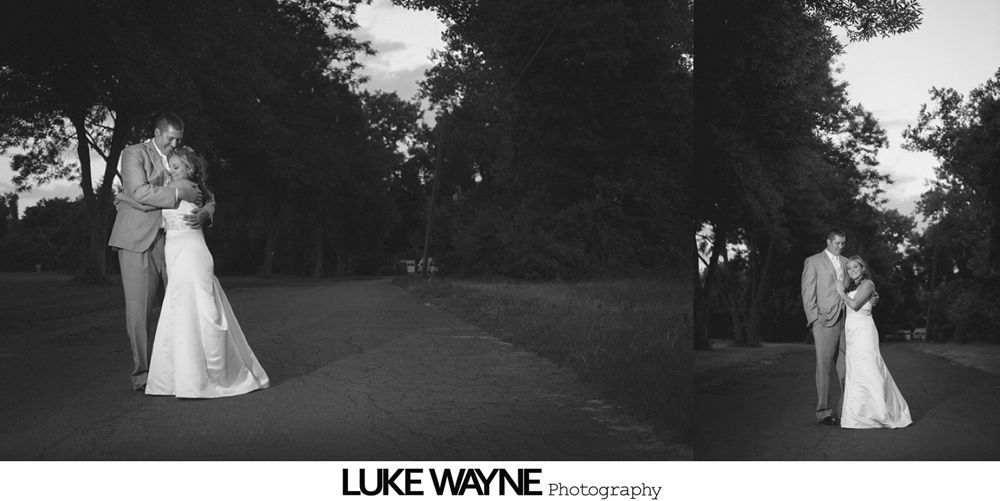 Man dances with a woman at a reception; indoor setting. Woman wears glasses and striped top. Person takes photo.