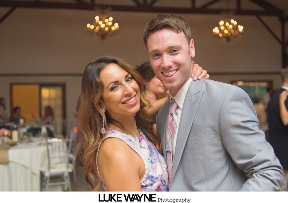 Wedding party carrying bride indoors with paper lanterns.